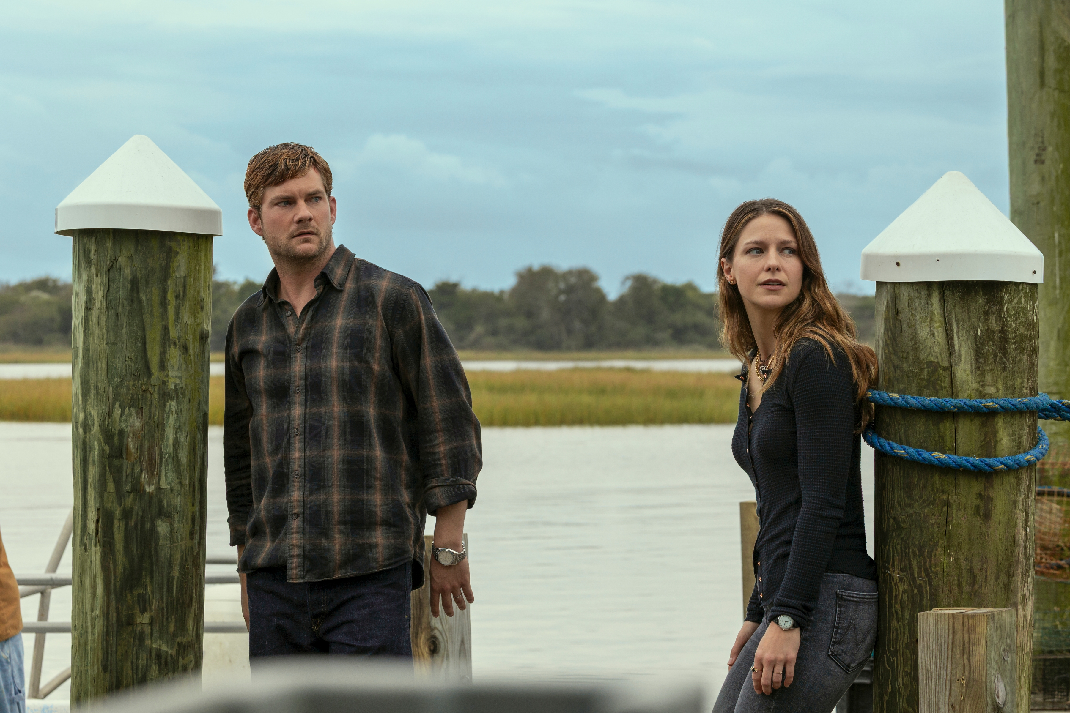 Jake Weary as Cane Buckley and Melissa Benoist as Bree Buckley as they look shocked standing on a dock in the waterfront