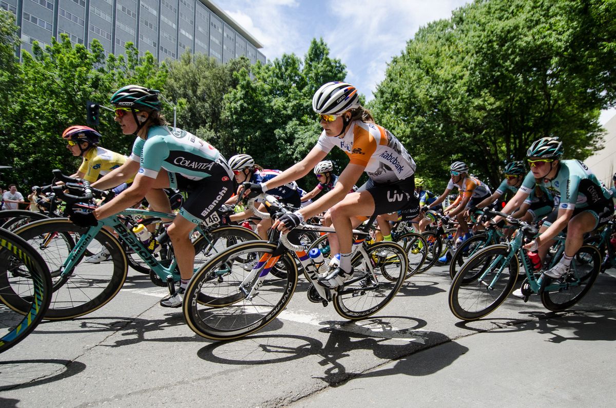 Riders lean through the last turn