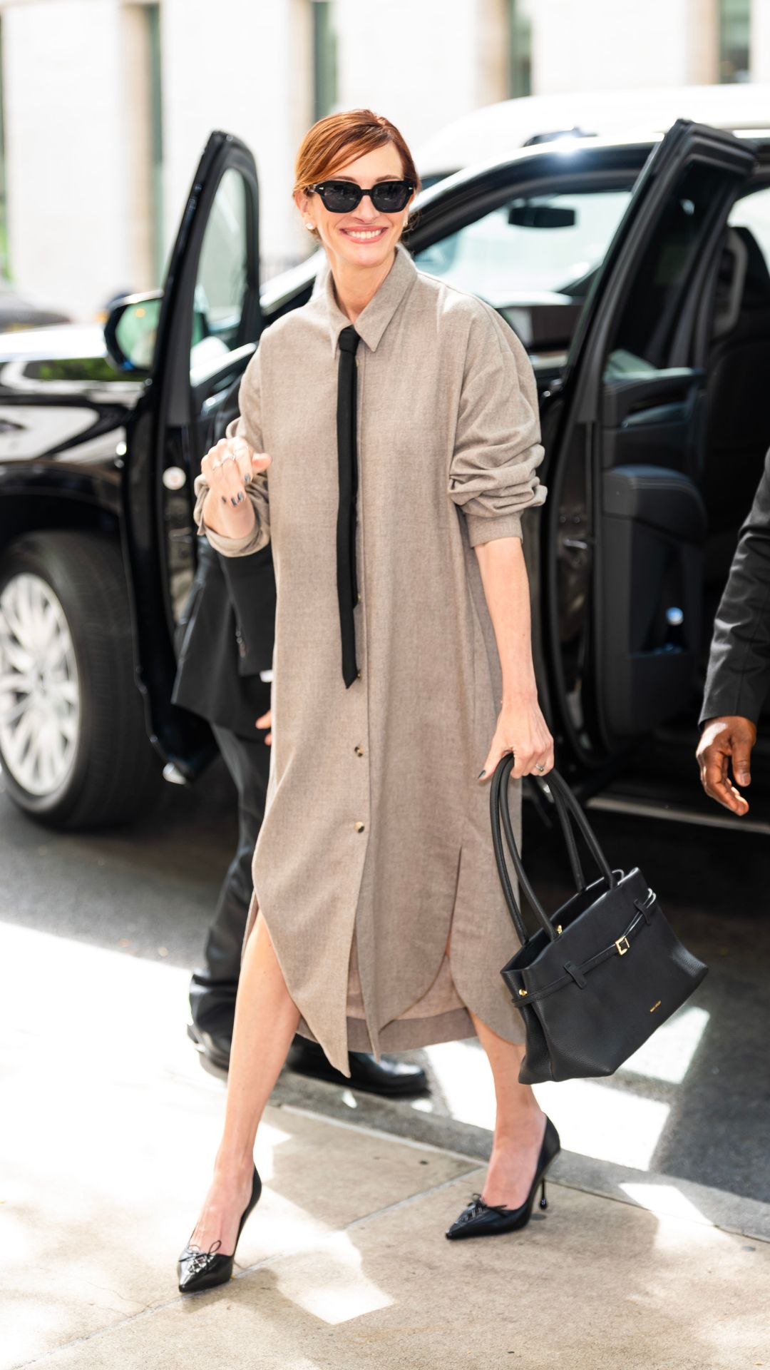 Julia Roberts wearing shirt dress, black tie and black Jimmy Choo heels on September 26, 2025 in New York City