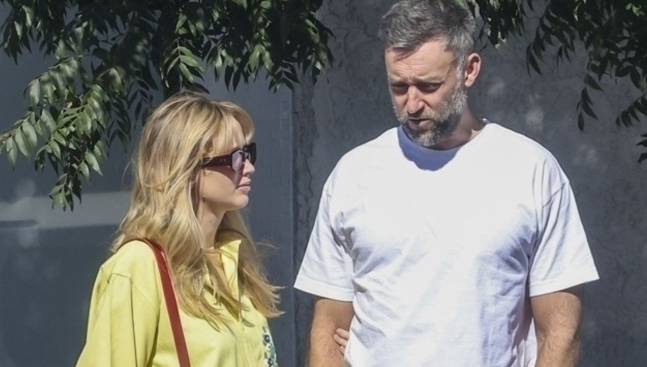 Jennifer Lawrence and Cook Maroney in Los Angeles where Lawrence wears a yellow button down shirt and black pants