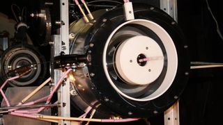 The test setup for a prototype air-breathing thruster and compressor, visible here inside a vacuum chamber.