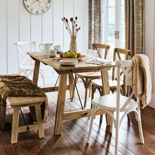 dining table with wooden floor and wall clock