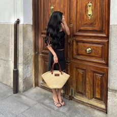 Woman posing in front of a door with long hair
