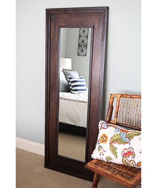 A wood framed mirror in bedroom using Rust-Oleum decorating products