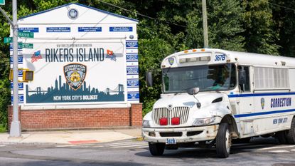 The entrance to Rikers Island is seen alongside a correctional bus in New York City.