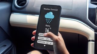 Person checking weather forecast on phone