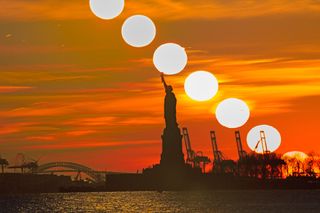 A composite image shows the sun setting gradually behind the Statue of Liberty.