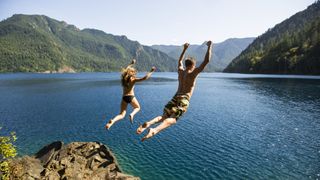 Man and woman cliff jumping