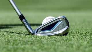 TaylorMade Kalea Premier Women's Irons resting on the fairway showing off their cool club head design