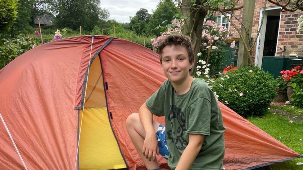 Boy camps in back garden