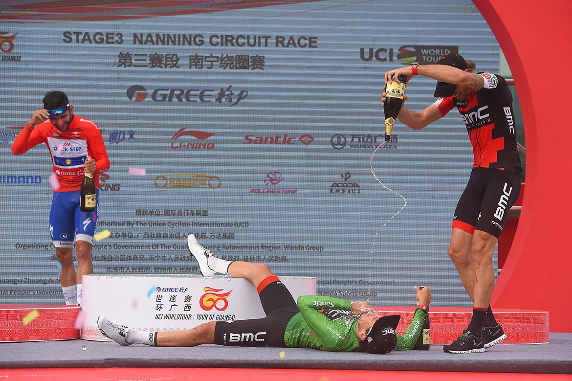 Daniel Oss does a Paul Gascoigne 'dentist's chair' on Silvan Dillier on the Tour of Guangxi podium