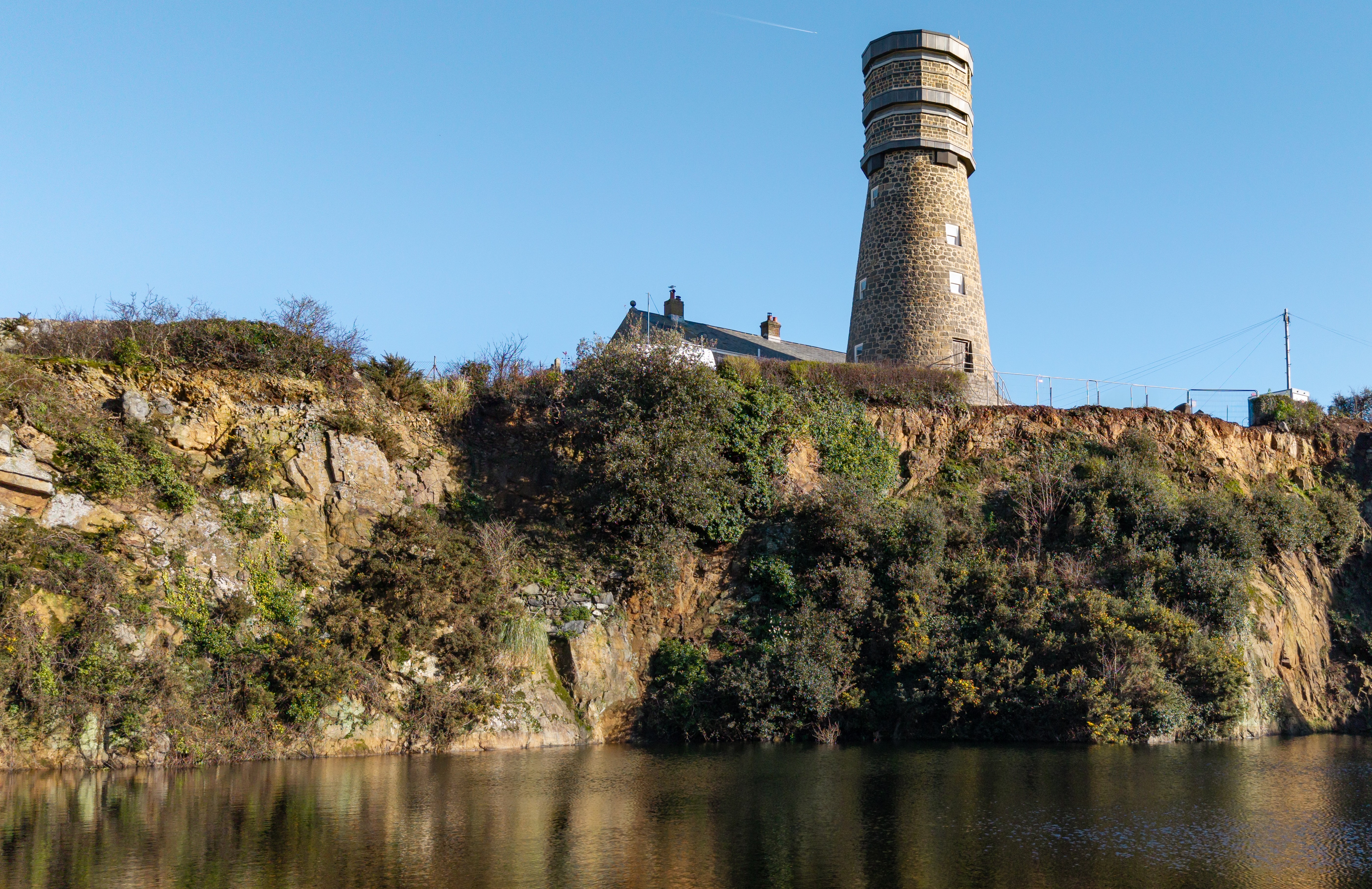 Images of a disused but restored Mill tower on the isle of Guernsey. It overlooks a quarry filled with water