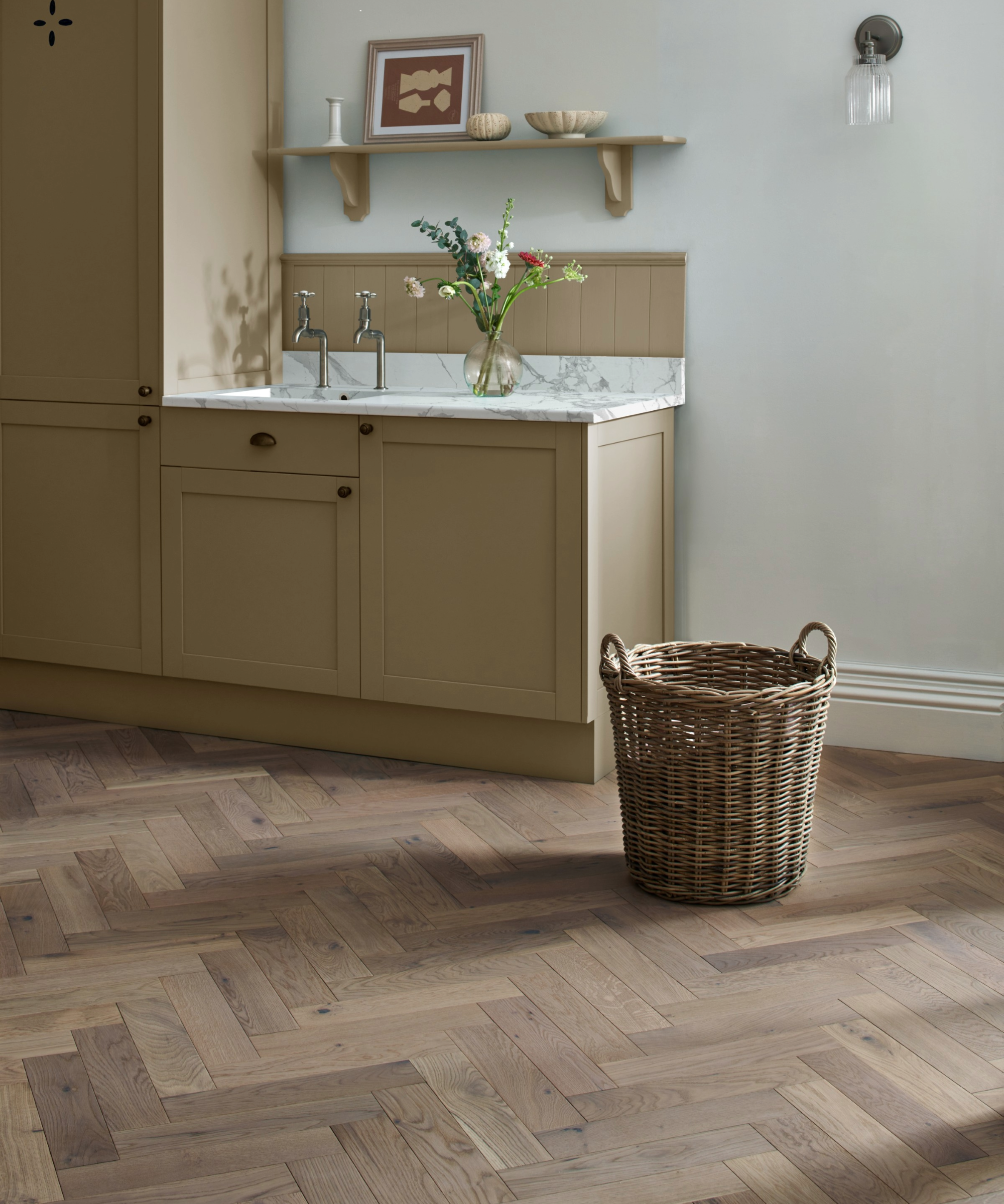 Kitchen with wooden flooring, marble worktop and mustard cabinets