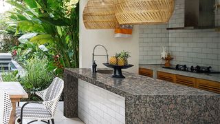 Outdoor kitchen ideas with granite worktops and pendant lights