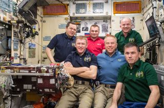 Expedition 47 crew poses for the three millionth ISS image