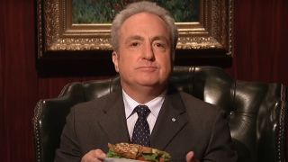 Lorne Michaels sits in a leather chair holding a salad on Saturday Night Live, S32 E4.