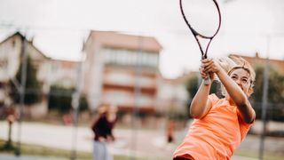Action shot of woman playing tennis