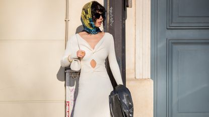guest wearing winter dress is seen outside Dior during Paris Fashion Week - Haute Couture Spring/Summer 2022 on January 24, 2022 in Paris, France