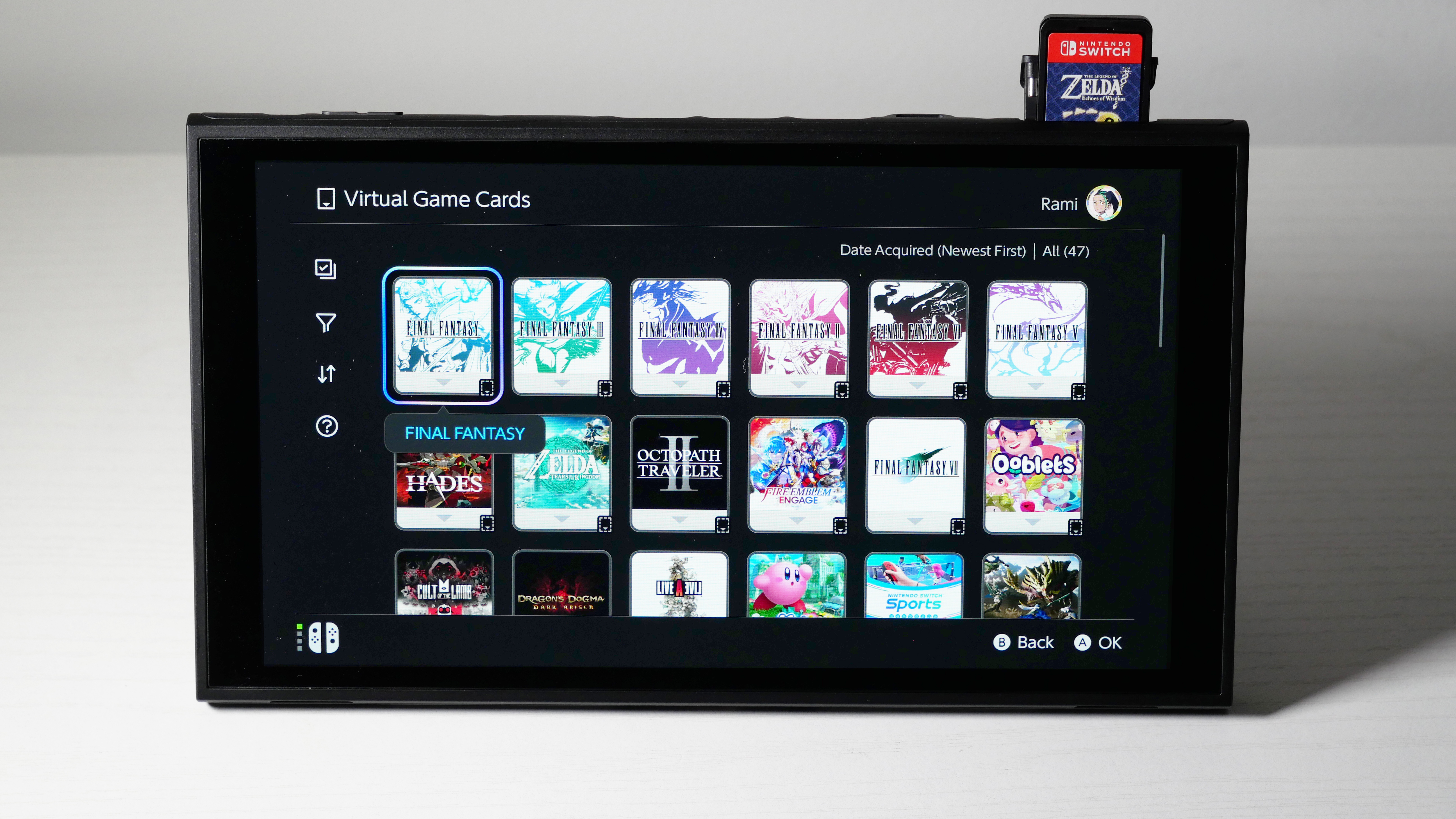 Nintendo Switch 2 on a white desk, displaying the Virtual Game Cards screen.