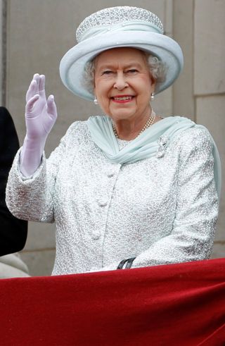 Queen Elizabeth II waving from palace balcony on her Diamond Jubilee in 2012 wearing brooch she gave a cheeky nickname