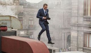 Daniel Craig as James Bond runs on a rooftop in the opening scene to Spectre