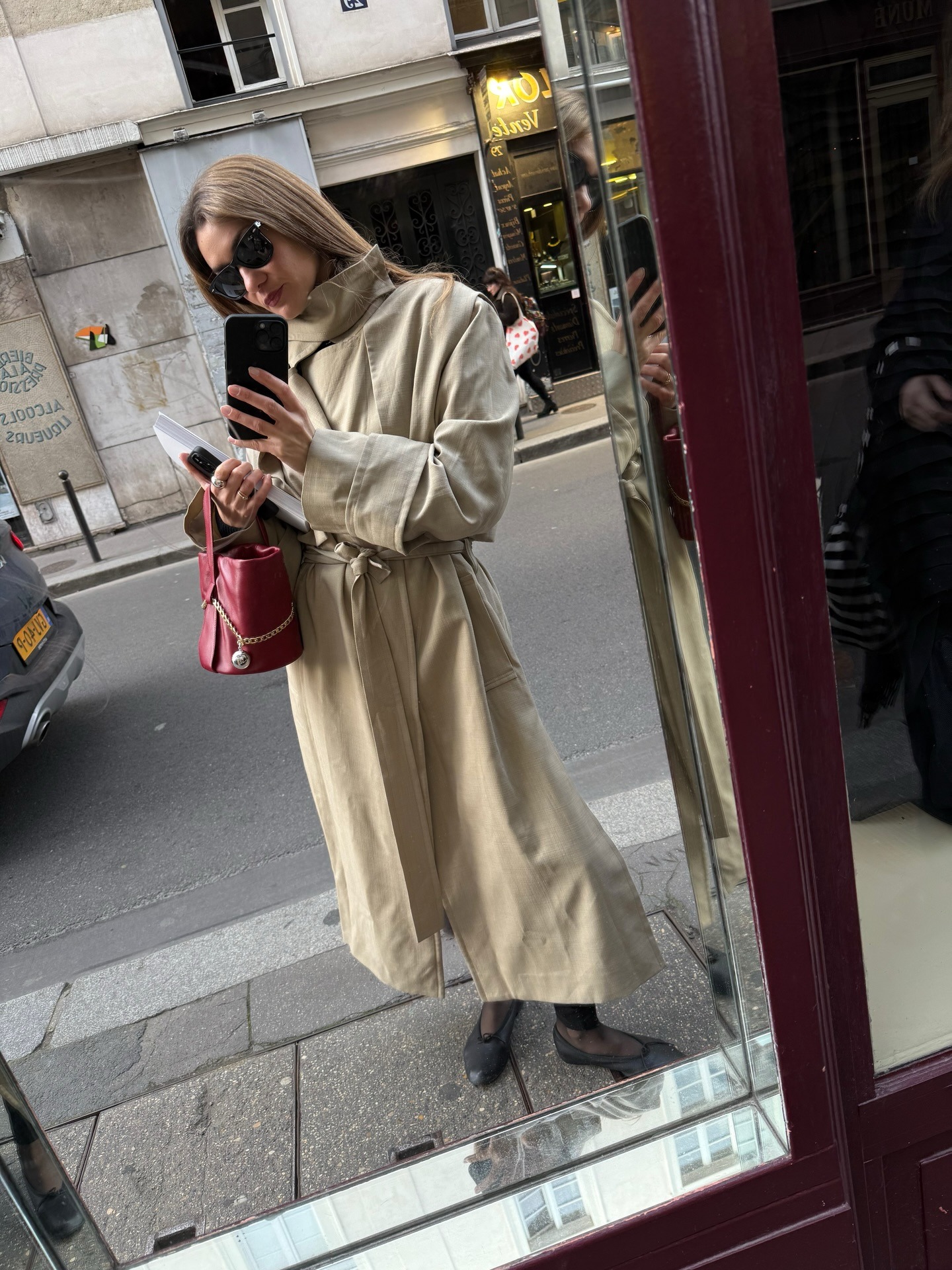 A French woman in a trench coat.