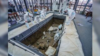 Archaeologists are shown excavating one of the six newly discovered pits at the site of Sanxingdui in China.