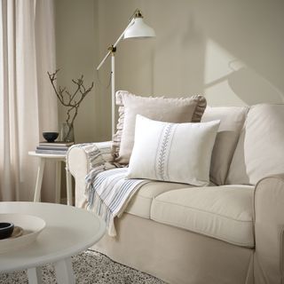 A living room with a neutral sofa and scandi style cushions
