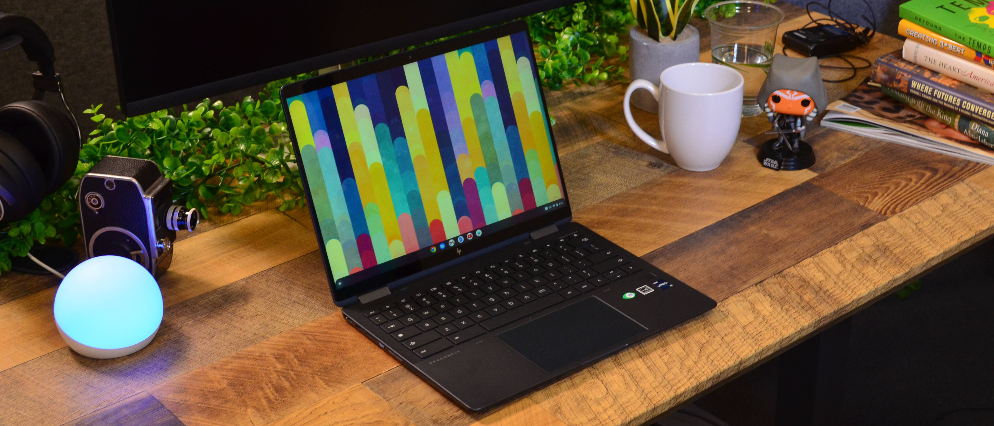 An HP Elite Dragonfly Chromebook on a wooden desk