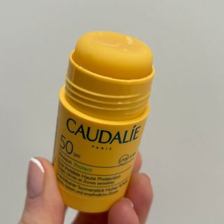 Laura holding Caudalie Vinosun Protect Stick Invisible Haute Protection - best sun creams