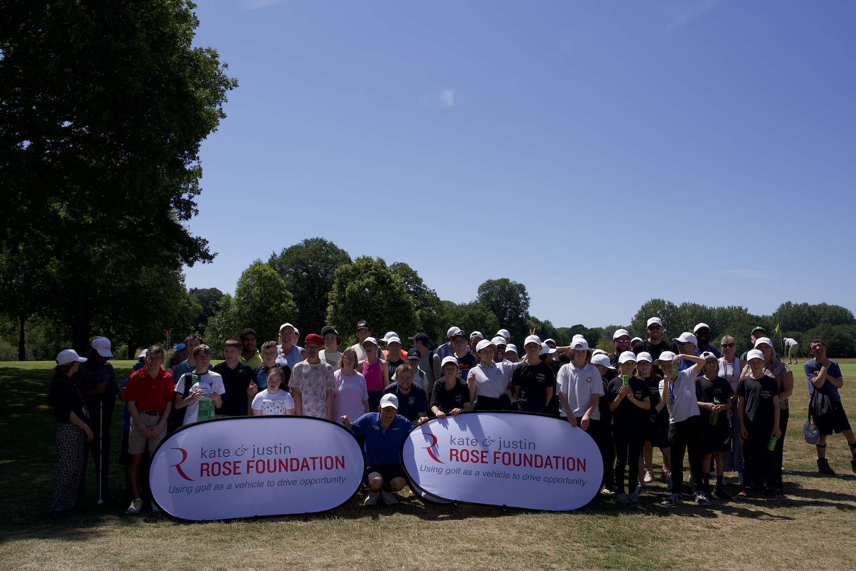Children posing on a golf course