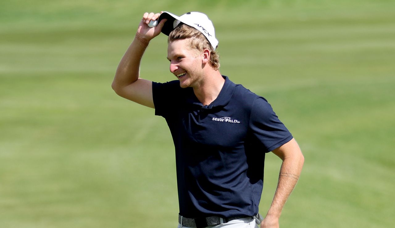 Bachem removes his hat as he celebrates his victory