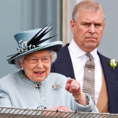 Queen Elizabeth wears a pale blue coat and matching hat as she watches horse races at Epsom with son ex-Prince Andrew