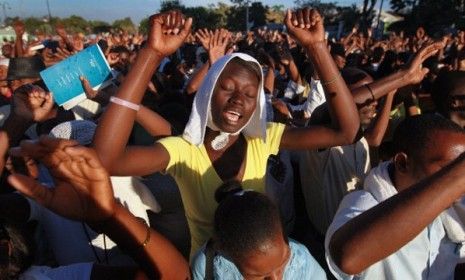 Haitians pray together on the one-year anniversary of the massive earthquake that rocked Port-au-Prince.