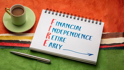 FIRE acronym - financial independence, retire early, handwriting in a sketchbook with a cup of coffee against colorful abstract paper landscape