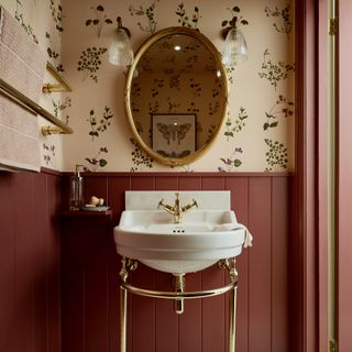 Red cloakroom with peach blush wallpaper