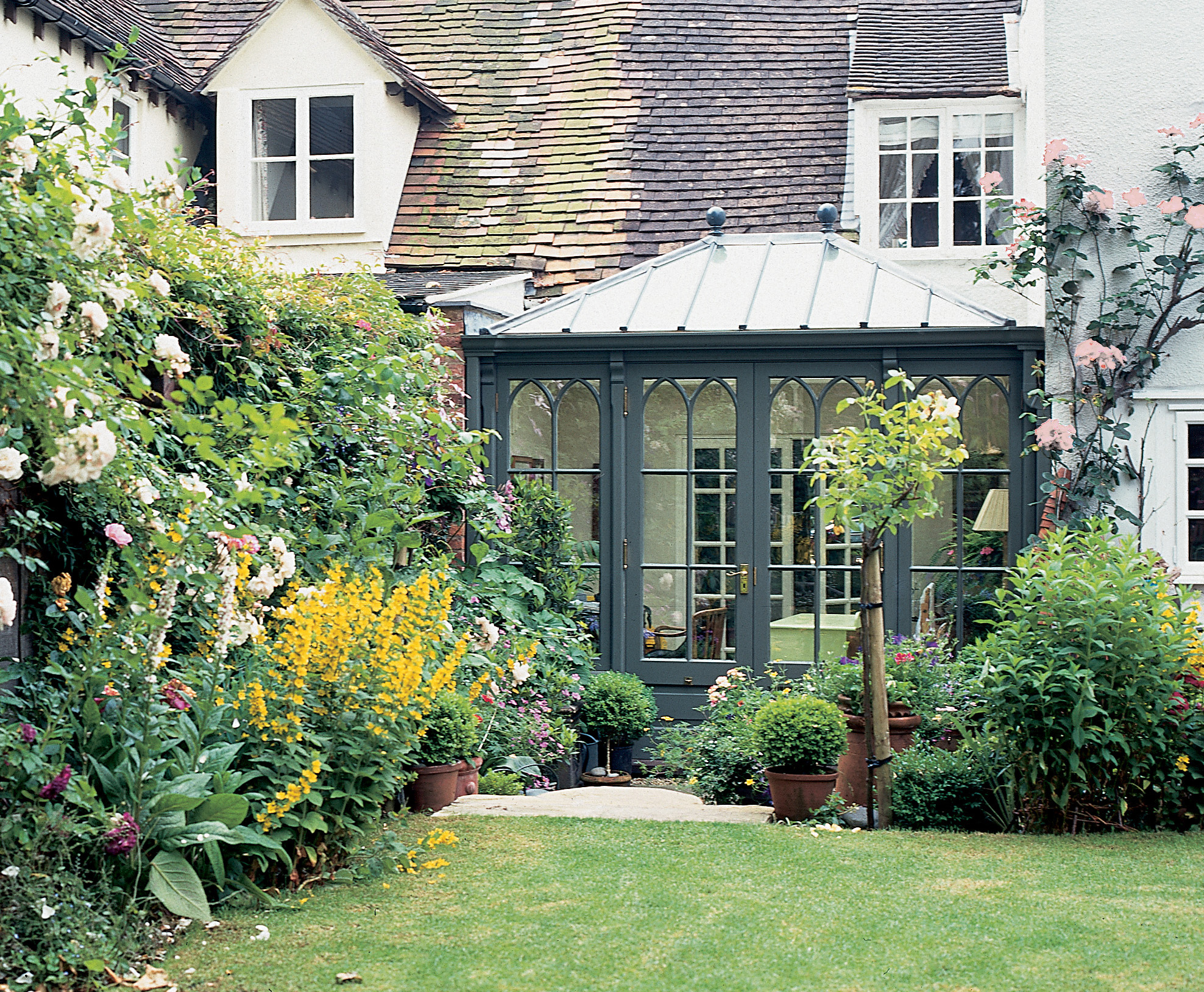 A pretty petrol blue conservatory on a period property