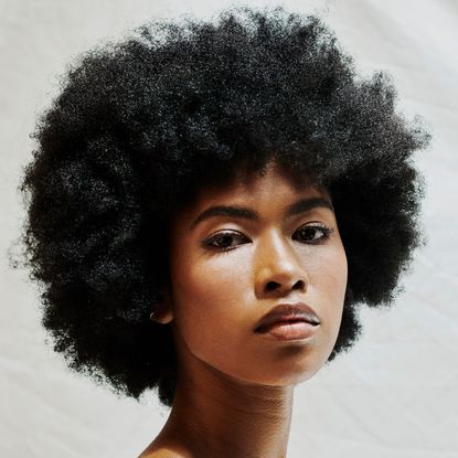 a picture of a woman looking at the camera - how to properly wash your hair