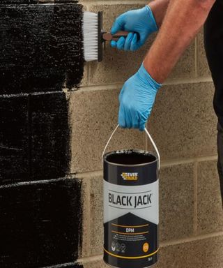 external wall being painted with black paint
