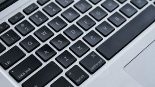 A close-up image of a MacBook keyboard showing the Apple Command key