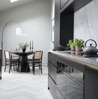 Monochrome kitchen with dining area and chevron floor