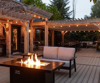 backyard deck with lighting and fire pit