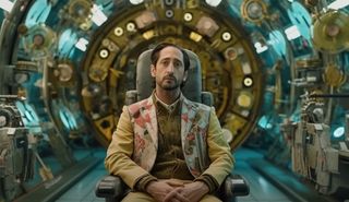 Adrien Brody sitting in a chair in a strange futuristic chamber, portraying Jake Sully in a new "Avatar" parody trailer.
