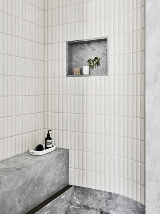 a small bathroom with a shower niche