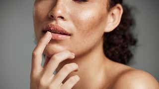 woman applying lip scrub