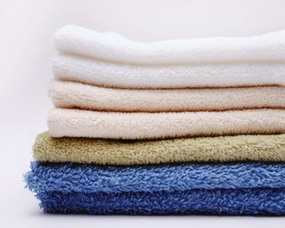 Fresh towels stacked up in neutral colors