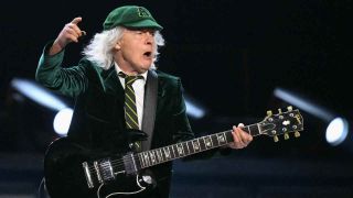 AC/DC’s Angus Young performing onstage at the Veltsin Arena in Gelsnekirchen, Germany
