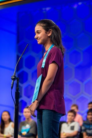Scripps National Spelling Bee second place finisher Naysa Modi at the microphone