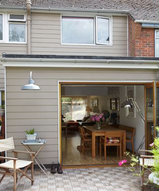 dinning table with chair exterior of house and cladding wall