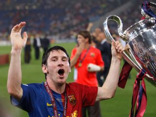 Lionel Messi celebrates with the trophy after Barcelona's victory over Manchester United in the 2009 Champions League final